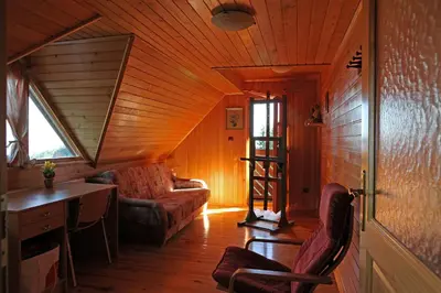 a living room with a couch and a desk in a house at Natural Wooden Sweetheart in Padeški Vrh