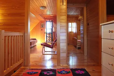 a hallway of a house with a chair in it at Natural Wooden Sweetheart in Padeški Vrh