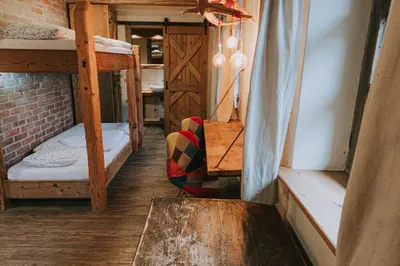 a hallway with a room with bunk beds at Hostel Lukna in Mojstrana
