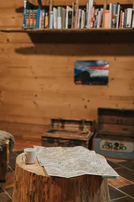 a coffee cup sitting on top of a wooden table at Hostel Lukna in Mojstrana