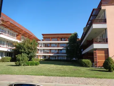 an apartment building with a lawn in front of it at Apartment Maja Moravske Toplice in Moravske Toplice