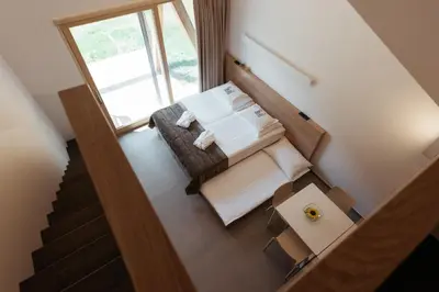 an overhead view of a room with a bed and a staircase at Hotel Ajda Depandance Prekmurska Vas - Terme 3000 - Sava Hotels & Resorts in Moravske Toplice