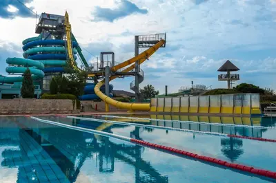 a water park with a water slide in the background at Hotel Ajda Depandance Prekmurska Vas - Terme 3000 - Sava Hotels & Resorts in Moravske Toplice