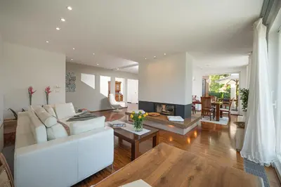 a living room with a white couch and a fireplace at Luxury Apartment Nana in Bled