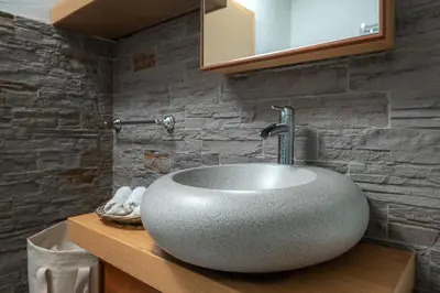 a bathroom with a white sink on a counter at Luxury Apartment Nana in Bled