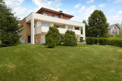 a house with a lawn in front of it at Luxury Apartment Nana in Bled