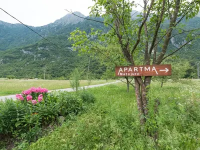 a street sign on the side of a road at Apartma Matajurc in Trnovo ob Soči