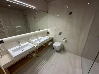 a bathroom with a sink and a toilet and a mirror at Terme Paradiso - Hotel Paradiso in Dobova