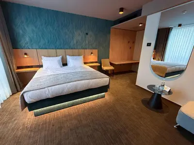 a hotel room with a bed and a chair at Terme Paradiso - Hotel Paradiso in Dobova
