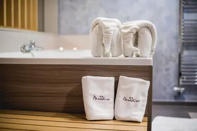 a bathroom with white towels and a sink at Terme Paradiso - Hotel Paradiso in Dobova