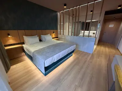 a bedroom with a large bed in a room at Terme Paradiso - Hotel Paradiso in Dobova