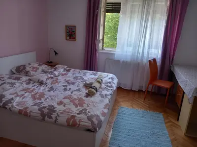 a bedroom with a bed with a camera on it at Rooms & Apartments MURGLE Ljubljana in Ljubljana
