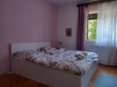 a bedroom with a bed and a window at Rooms & Apartments MURGLE Ljubljana in Ljubljana