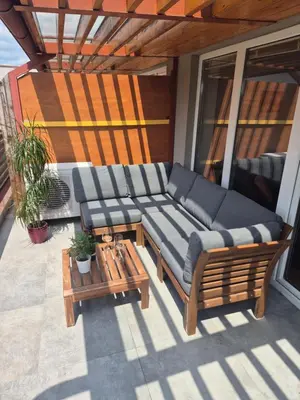 a porch with a couch and a table on a balcony at Apartment Paradise in Moravske Toplice