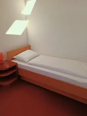 a small bedroom with a bed and a window at Apartment Paradise in Moravske Toplice