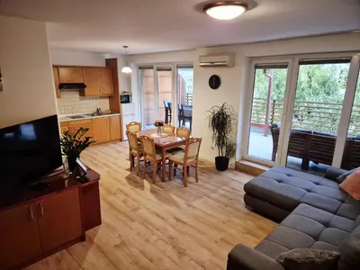 a living room with a table and a couch at Apartment Paradise in Moravske Toplice