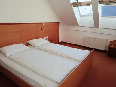 a bedroom with a large bed with white sheets at Apartment Paradise in Moravske Toplice