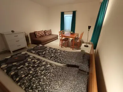 a living room with a couch and a table at Tiptop Apartment & Outdoor Activities in Bovec