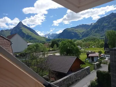 a view of mountains from the balcony of a house at Tiptop Apartment & Outdoor Activities in Bovec