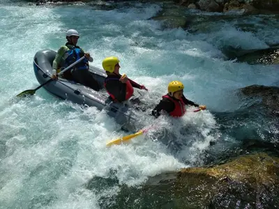 three people in a raft in a river at Tiptop Apartment & Outdoor Activities in Bovec