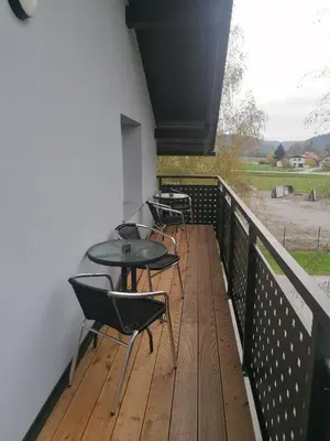 a balcony with four tables and chairs on it at Apartments & rooms Saša in Podčetrtek