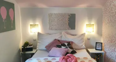 a bedroom with a bed with pillows on it at Apartments & rooms Saša in Podčetrtek
