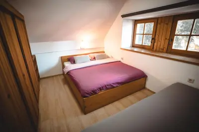 a small bed in a small room with a window at POČITNIŠKI APARTMAJI - Sunny apartment in Moravske Toplice in Moravske Toplice