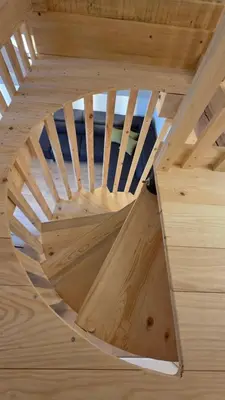 a wooden spiral staircase in a wooden house at Domačija Loncnar in Bohinj