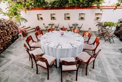 a table with chairs and a white table cloth at Apartments Avio in Zgornji Brnjik