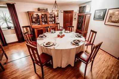 a dining room with a white table and chairs at Apartments Avio in Zgornji Brnjik