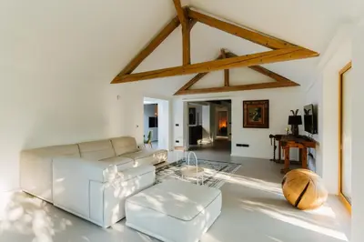 a living room with a white couch and a table at Villa LISA - VILLA WITH SWIMMING POOL AND HUGE GARDEN in Mozirje