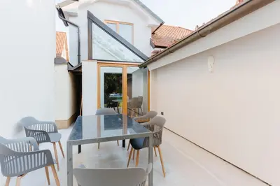 a dining room with a glass table and chairs at Villa LISA - VILLA WITH SWIMMING POOL AND HUGE GARDEN in Mozirje