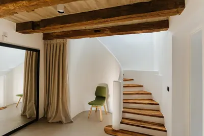 a staircase in a house with a green chair at Villa LISA - VILLA WITH SWIMMING POOL AND HUGE GARDEN in Mozirje