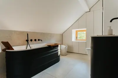 a bathroom with a large tub in a room at Villa LISA - VILLA WITH SWIMMING POOL AND HUGE GARDEN in Mozirje