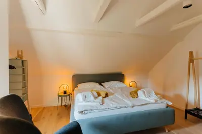 a bed with white sheets and pillows in a room at Villa LISA - VILLA WITH SWIMMING POOL AND HUGE GARDEN in Mozirje