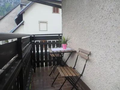 a table and a bench on a balcony at Apartments Pod Bregom in Kranjska Gora
