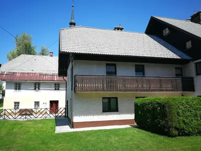 a large white building with a balcony on it at Apartments Pod Bregom in Kranjska Gora