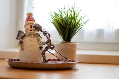 a statue of a snowman in a bowl on a table at Apartments Pod Bregom in Kranjska Gora