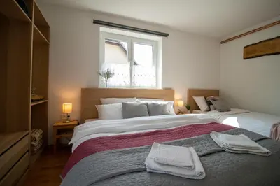 a bedroom with two beds and a window at Apartments Pod Bregom in Kranjska Gora