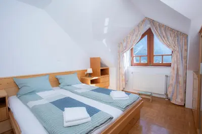 a large bed in a room with a window at Apartment Tinka Kranjska Gora in Kranjska Gora