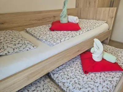 two bunk beds with trams on top of them at Apartma SIMONA in Bohinj