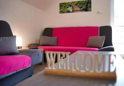a living room with two couches and a red couch at Apartma SIMONA in Bohinj