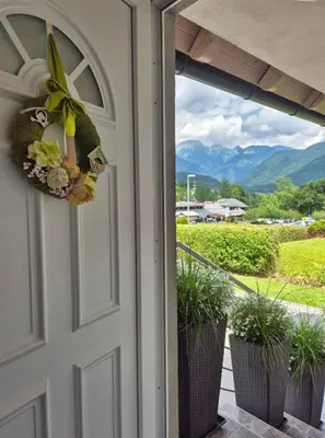 a door to a porch with a view of mountains at Apartma SIMONA in Bohinj