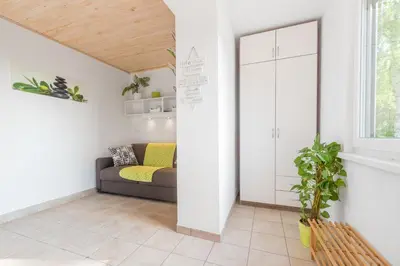 a living room with a couch and a window at Apartment - Speleo Camp in Logatec