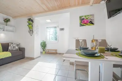 a living room with a table and a couch at Apartment - Speleo Camp in Logatec
