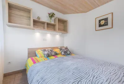 a bedroom with a large bed in a white room at Apartment - Speleo Camp in Logatec