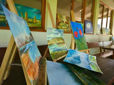 a group of paintings sitting on a table at Tourist Farm Strle With Great Local Food in Cerknica