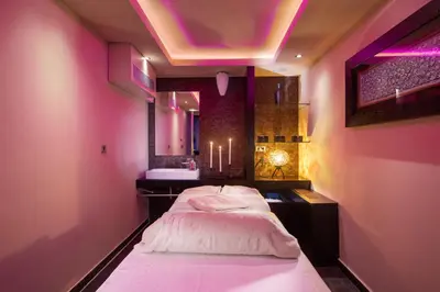 a pink room with two beds and a sink at Hotel Aleksander Medical & SPA in Rogaška Slatina