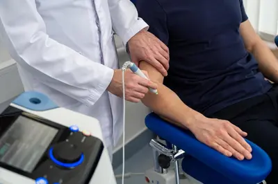 a doctor injecting a patients knee with a needle at Hotel Aleksander Medical & SPA in Rogaška Slatina