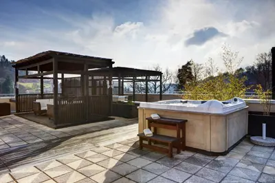 a bath tub on a patio with a gazebo at Hotel Aleksander Medical & SPA in Rogaška Slatina